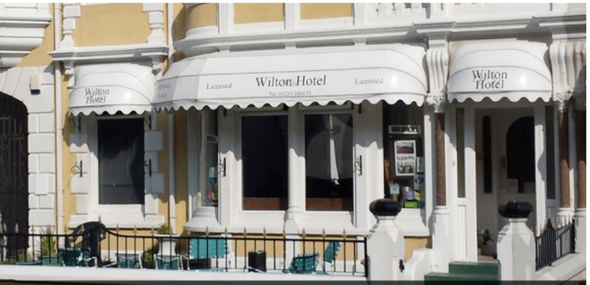 The Wilton Hotel's Victorian frontage at dusk with the sea beyond